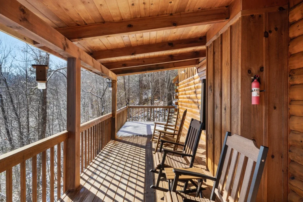 Row of rocking chairs on the porch of a Smoky Mountain cabin near Dollywood