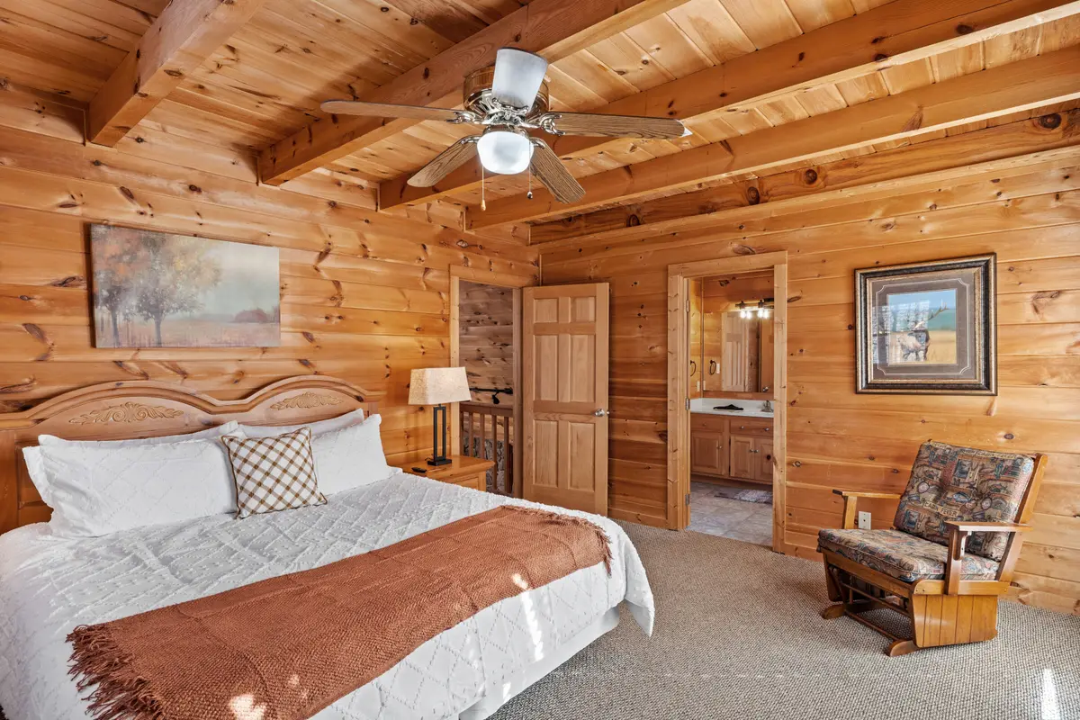 Upper-level king bedroom with ensuite bathroom and private balcony access
