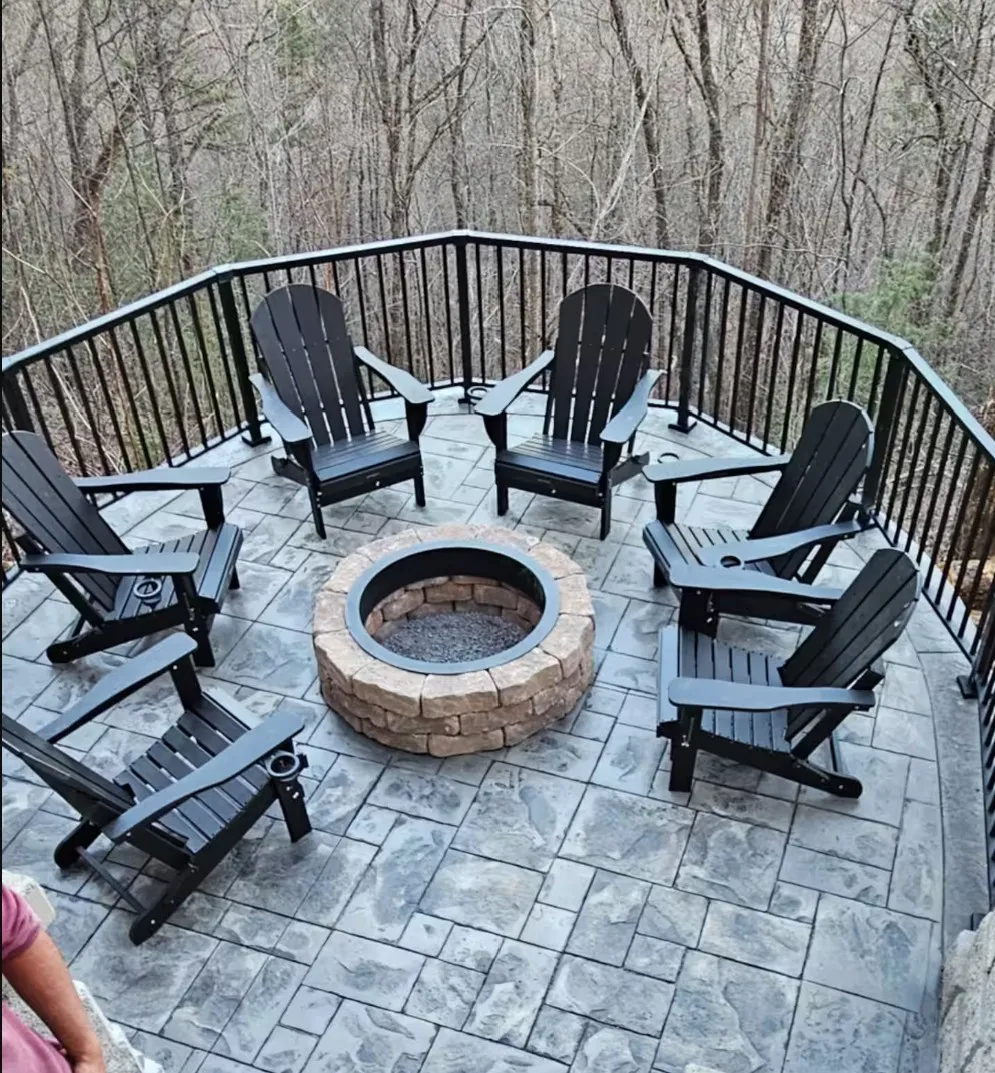 Stone fire pit surrounded by Adirondack chairs at this cabin near Gatlinburg