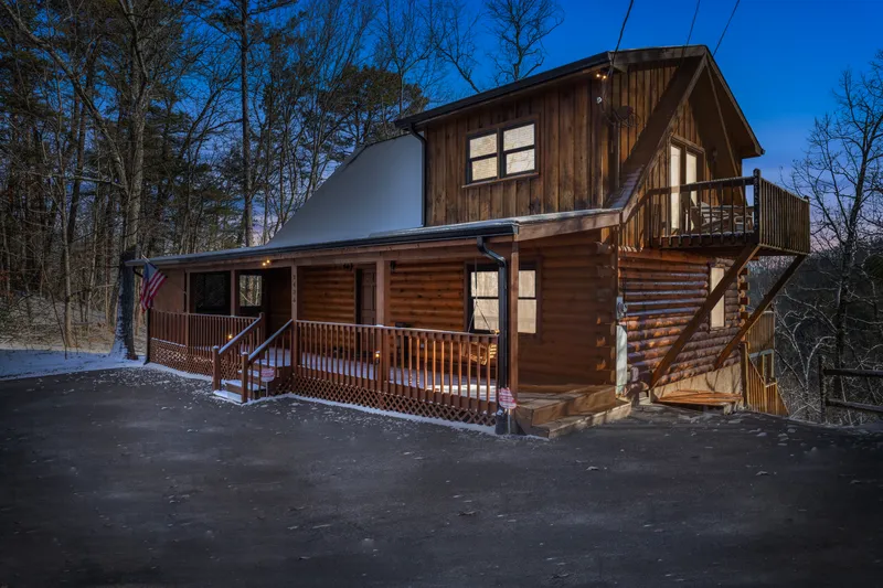 The cabin at dusk with glowing windows