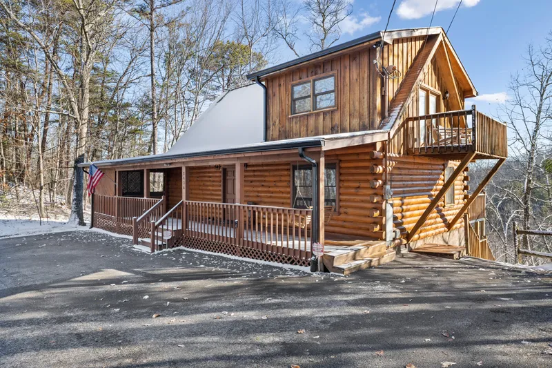 Cabin exterior with covered porch and parking