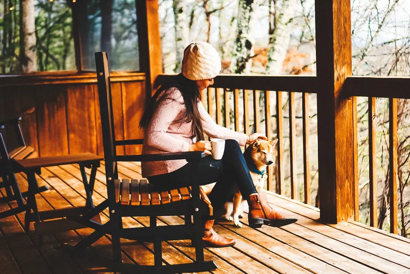 Ariana and the dog relaxing in the porch rocking chairs